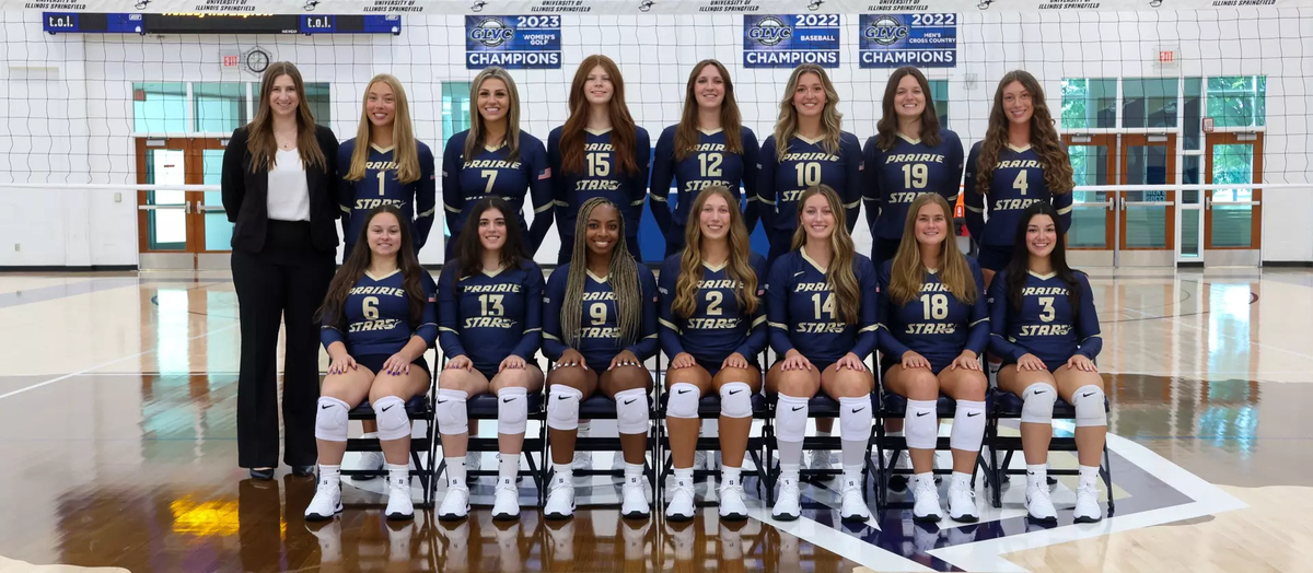 2025 UIS Volleyball Official Team Photo, athletes in navy blue uniform, also featuring Coach Ulrich