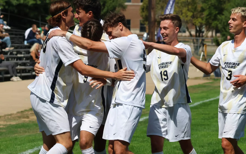 UIS men's soccer athletes in white UIS uniforms celebrate a goal