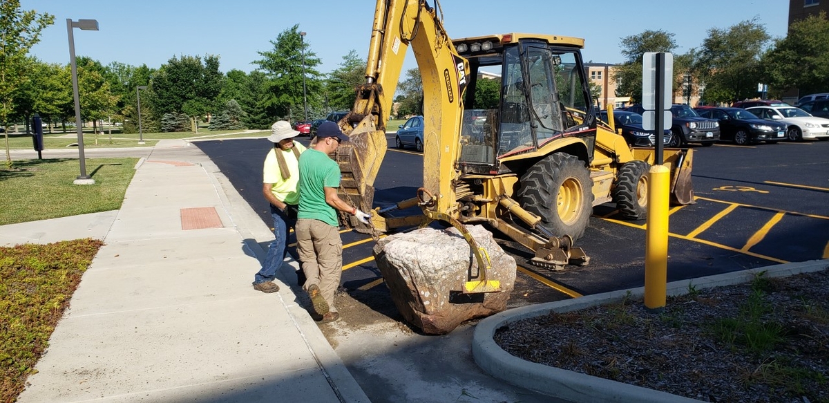 Grounds crew working with a digger.
