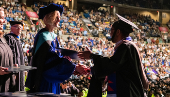 Chancellor Gooch shaking grads hand