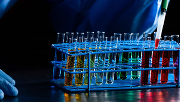 test tubes being filled with colorful liquid