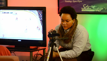 student photographing another student