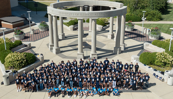 A mass group shot of the UIS Class of 2029 in front of the colonnade. 