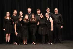 photo of a group of student musicians in front of a black backdrop