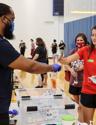 Students dropping off saliva samples