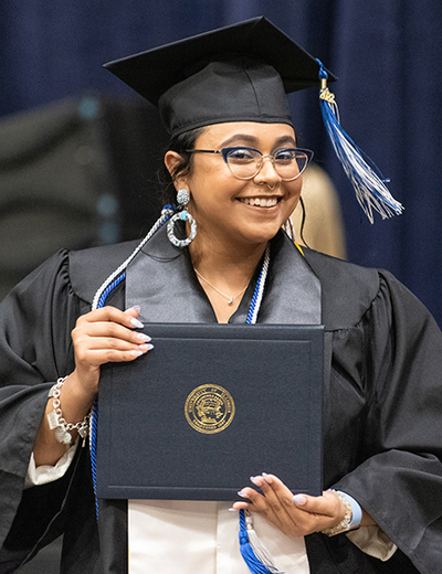 Graduate holding diploma cover