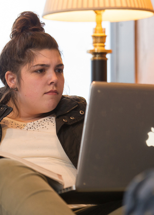 A student studies on her laptop at home.