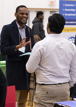 Student talking with employer at expo