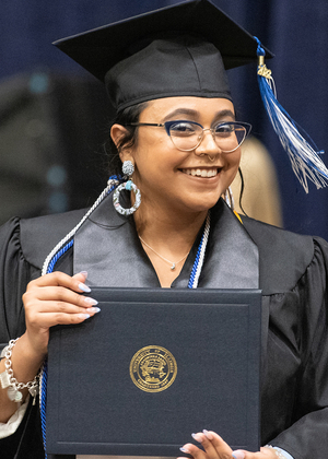 Graduate holding diploma cover