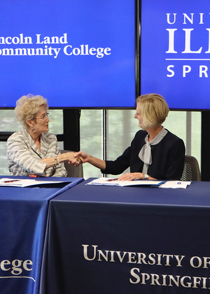LLCC President Charlotte Warren and UIS Chancellor Janet Gooch shake hands