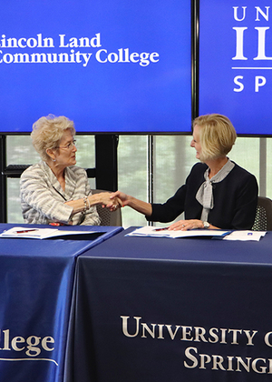 LLCC President Charlotte Warren and UIS Chancellor Janet Gooch shake hands