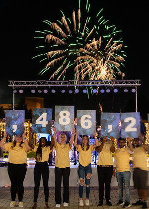 UIS students reveal the amount of money raised by the Reaching Stellar Campaign during an event on campus.