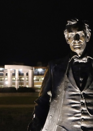 UIS Young Lincoln Statue lit at night with colonnade in the background