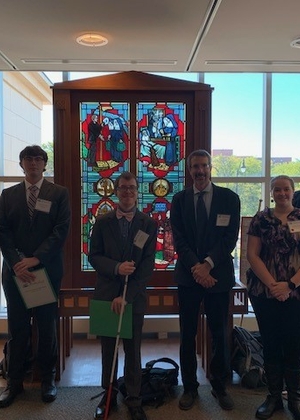 Five students stand next to Professor Peter Shapinsky before presenting at the 2023 Conference on Illinois History.