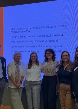 Dr. Devin Hunter, Amy Hathaway (Illinois State Historic Preservation Office) and UIS Public History grad students McKenna Servis, Amy Kapp, Kaitlin Pottier, and Hayley Goebel stand together after the students' presentation at the 2023 Conference on Illinois History.