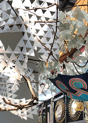 A tree of light and a a chandelier made from an umbrella, festooned with shards of frosted glass.