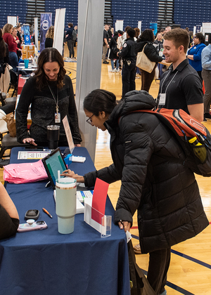 Students filling out papers at the Career Connections Expo