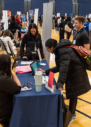 Students filling out papers at the Career Connections Expo