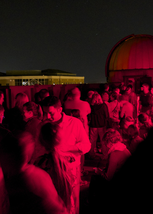 A crowd of people on the roof of Brookens Library for a Star Party.