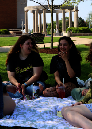 A picture of friends having a picnic on the quad.