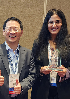 Brian Chen and Zainab Yaseen pose with the award.