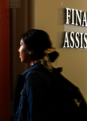 A student walking into the Financial Aid Office.