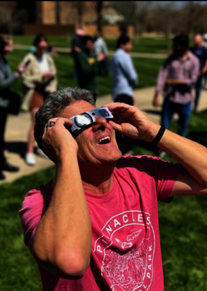 man wearing solar eclipse glasses