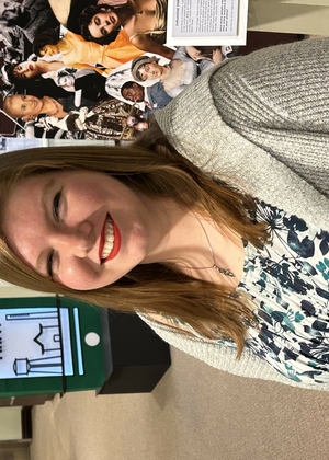 Katie Brethorst standing in the Grayslake Heritage Center and Museum smiling at the camera.