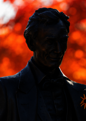 Statue of Abe Lincoln with orange flower in his lapel