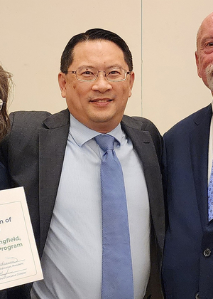 Lenore Killam, Brian Chen and a third person pose with the Illinois Public Health Association Public Health Program award.