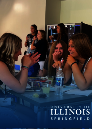 A group of young women are enjoying social time with refreshments and games at the University of Illinois Springfield.