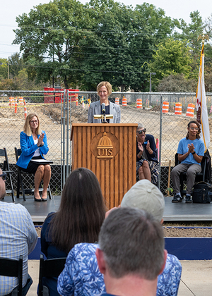 Chancellor Janet Gooch speaks at a podium during the UIS Library Commons groundbreaking ceremony.