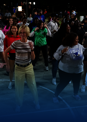 Chancellor Gooch dances with a crowd of students at RecPalooza.