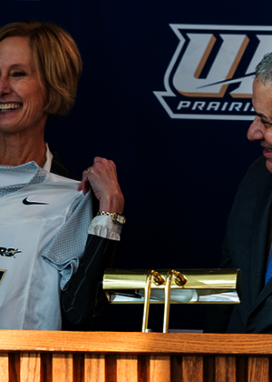 Chancellor Janet Gooch holds up a UIS women's flag football jersey with Athletic Director Mike Herman.