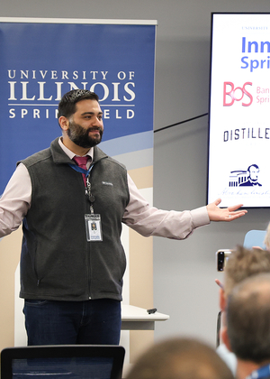 Man speaking to an audience in a conference room.