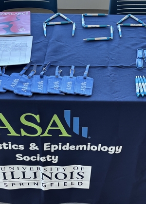 ASA table display with flyers, brochures, and University of Illinois logo.