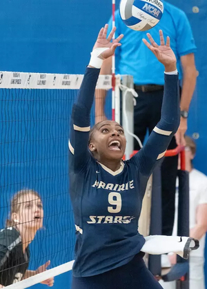 Erica Sledge setting the ball