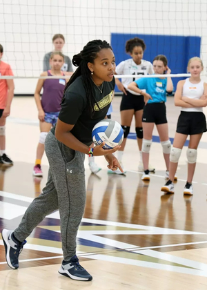 Kamille Jones coaches young athletes at volleyball camp