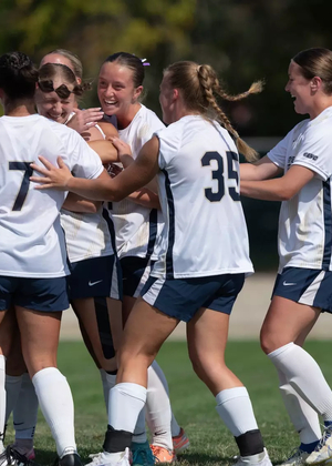 Women's soccer team celebrates a goal
