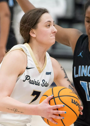 Kennedy Osterman playing basketball in white UIS uniform