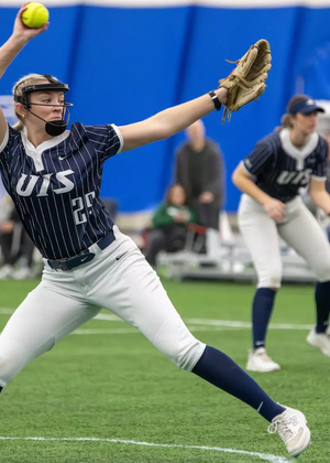 Calista Stahlhut pitching in blue UIS softball uniform