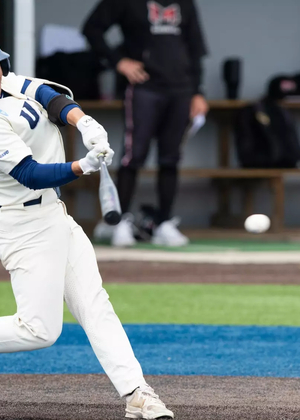 Tommy Atkinson playing baseball in white UIS uniform