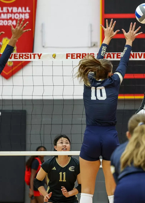 UIS Volleyball players go up for a block
