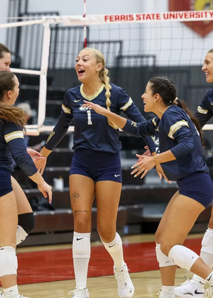 UIS Volleyball team celebrating on court at Ferris State tournament