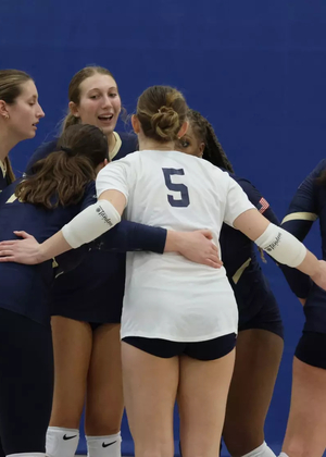 Volleyball Team huddle after a point