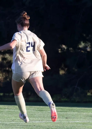 Riley Lloyd playing soccer in UIS gold