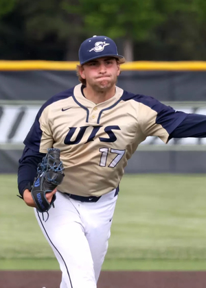 Graham Kasey pitching for UIS baseball in gold jersey