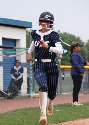 Jaden Watts running home in a softball game