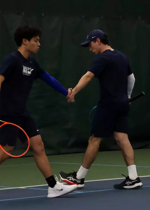 Lin En Tan and Pablo Herrera high five during doubles match