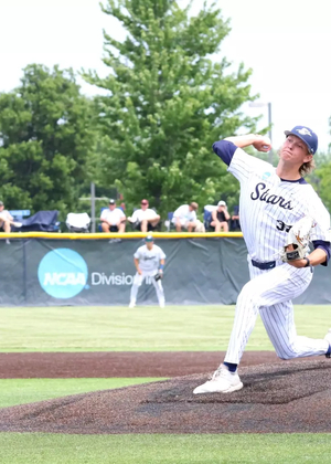 Mark DeCicco pitching at UIS Baseball Field in white uniform